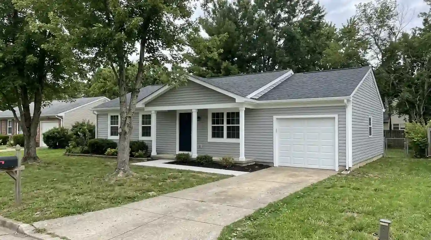 Vinyl siding painted light gray on a ranch house